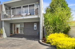 a house with a balcony on the side of it at MURRAY GRANGE VILLA 4 in Yarrawonga