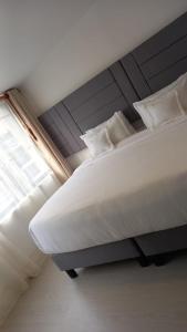 a large bed in a room with a window at Hotel Boutique FC in Bogotá
