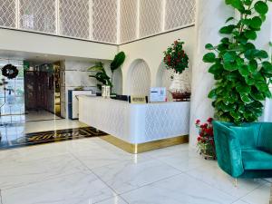 a lobby with a reception desk and plants at TIFFANY HOTEL & RESTAURANT in Phan Thiet