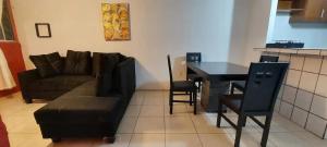 a living room with a couch and a table at Departamento cerca de la playa in Puerto Vallarta +6 photos