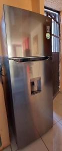 a stainless steel refrigerator sitting in a kitchen at Departamento cerca de la playa in Puerto Vallarta