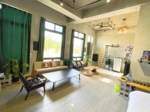 a living room with a couch and a table at 隱月民宿 in Hengchun South Gate