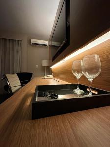 two wine glasses sitting on top of a kitchen counter at Flat Radisson Blu São Paulo in Sao Paulo