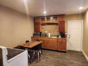 a kitchen with wooden cabinets and a table in it at spacious and indulging in Meriden