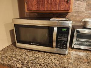 a microwave sitting on a counter in a kitchen at spacious and indulging in Meriden