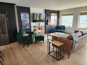 a living room with a couch and chairs at Seaclusion Twillingate in Twillingate