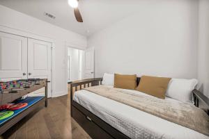 a bedroom with a bed and a table with games on it at Sandy Serenity Retreat in Panama City Beach