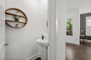 a white bathroom with a sink and a mirror at Sandy Serenity Retreat in Panama City Beach +44 photos