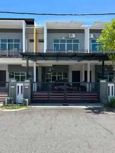 a building with a porch and a gate in front at Calm Home in Kuala Terengganu in Kuala Terengganu