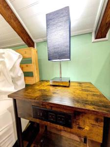 a wooden table with a lamp on top of it at Walkable Elmwood Cottage, No Chores 2Bath 2BR 2Car in Buffalo