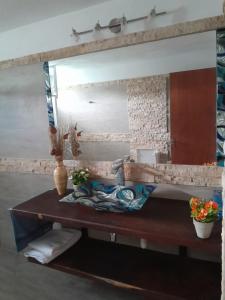 a bathroom with a sink and a large mirror at Casa de Campo La Querencia in Mercedes