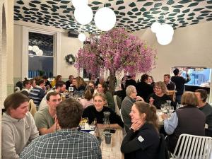 a group of people sitting at tables in a restaurant at Railway Hotel in Winton