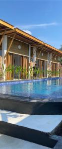 een groot zwembad voor een huis bij SUN RESORT GILI TRAWANGAN in Gili Trawangan