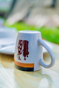 a coffee mug with a dog on it on a table at Maasai House - Arusha in Sokon
