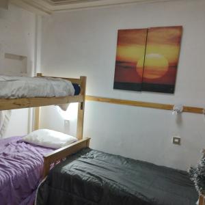 a bedroom with two bunk beds and a painting on the wall at Buenos aires Obelisco in Buenos Aires