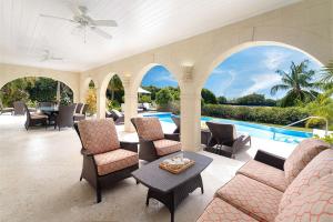 an indoor patio with chairs and a pool at Royal Westmoreland - Ocean Drive 8 villa in Saint James