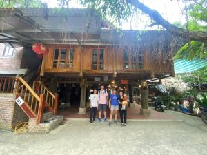 Chez Thuc Home’stay في Thanh Hóa: مجموعة أشخاص واقفين أمام مبنى