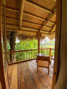 un porche de una casa con una mesa y un árbol en Chez Thuc Home’stay, en Thanh Hóa