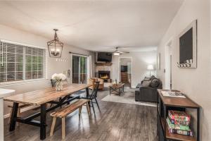 a dining room and living room with a table and chairs at Cozy Townhome with Wildlife Views! 5-min walk to Midtown! Modern Look in Ruidoso