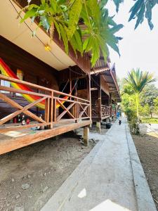 a building with a porch on the side of it at Jungle bangalow in Muang Không