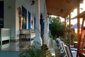 a building with chairs and tables on a patio at Belvilla Tranquil Oasis Lovina BeachNearKrisna Funtasticland in Lovina