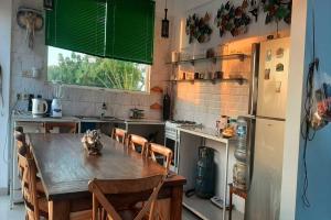 een keuken met een houten tafel en een koelkast bij Tranquil Oasis Villa Near Lovina Beach in Temukus