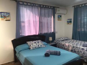 Ένα ή περισσότερα κρεβάτια σε δωμάτιο στο Casa Turistica Dónde MATHY'S #1 Barrio Sarie Bay