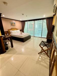 a large bedroom with a bed and a large window at Red Coco Inn de Boracay in Boracay