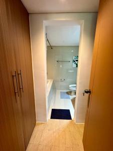 an open door to a bathroom with a toilet at 2br Golfcourse view near airport in Manila