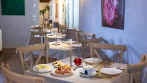 a dining room with tables and chairs with food on them at Hotel Cortaccia Sanvitale in Sala Baganza +98 photos