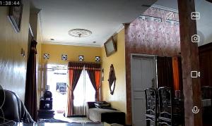 a living room with a bed and a window at Guest House Dissa in Purwokerto