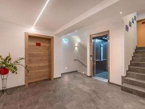 an empty hallway with stairs and a door at Gasthof Schöntal in Oberau