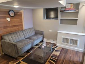 a living room with a couch and a table at The Subterranean Haven in Mount Vernon