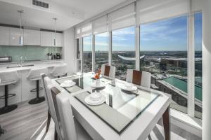 a kitchen and dining room with a view of the city at Downtown condo near Stampede, LRT, free parking & gym in Calgary