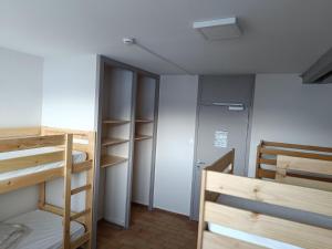 a room with two bunk beds and a closet at La Mansio de Bons in Les Deux Alpes