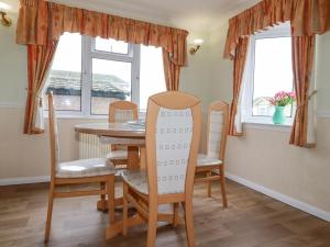 a dining room with a table and chairs at Summer Breeze in Padstow