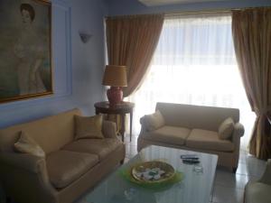 a living room with a couch and a coffee table at Triton Hotel Piraeus in Piraeus