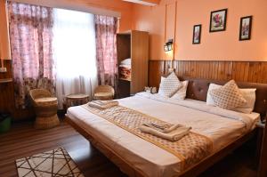 a bedroom with a large bed with two shoes on it at STAR HOTEL in Srinagar