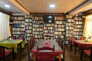 a library with tables and chairs and books at STAR HOTEL in Srinagar