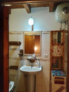 a bathroom with a sink and a mirror at Casa vacanza Su Niu in Iglesias