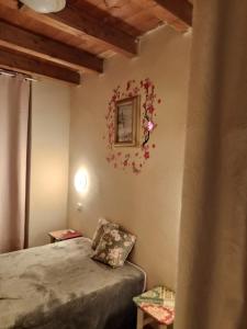 a bedroom with a bed and a picture on the wall at Casa vacanza Su Niu in Iglesias