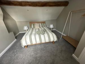 a bedroom with a bed and two lamps in it at The Open Ditch Apartment in Worcester