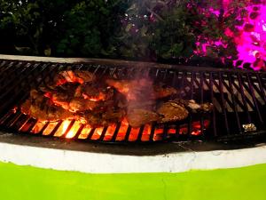 a grill with some food cooking on it at ITALIAN GUEST in Trincomalee