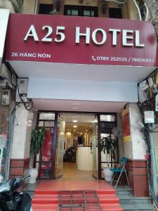 a hotel with a red sign over the door at A25 Hotel - 26 Hàng Nón in Hanoi