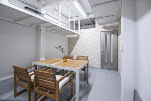 a dining room with a wooden table and chairs at - UMI-Haven 福島 - 隣駅5LDK戸建 in Osaka +22 photos