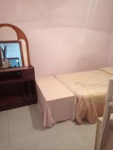 a bedroom with two beds and a mirror at Barcelona Appartment in Santa Coloma de Gramanet