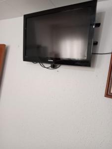 a flat screen tv hanging on a wall at Barcelona Appartment in Santa Coloma de Gramanet