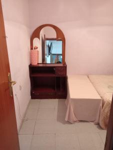 a bedroom with a dresser and a mirror at Barcelona Appartment in Santa Coloma de Gramanet