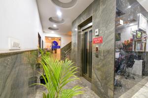 a lobby of a building with a plant at Hotel Grand Qubic Near Delhi Airport in New Delhi