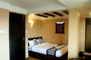 Postel nebo postele na pokoji v ubytování Hotel Garuda